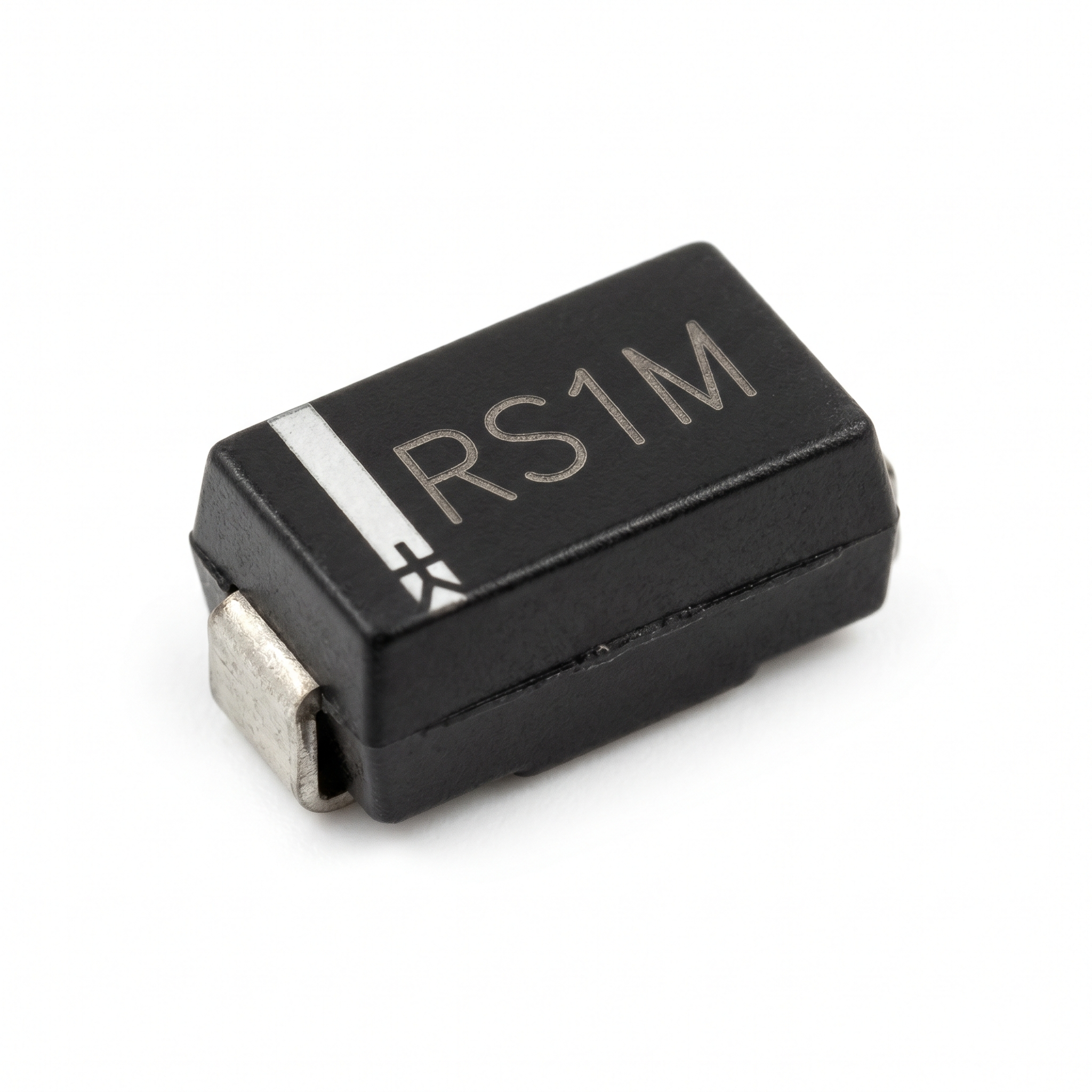 Small electronic component with 'RS1M' marking on a white background