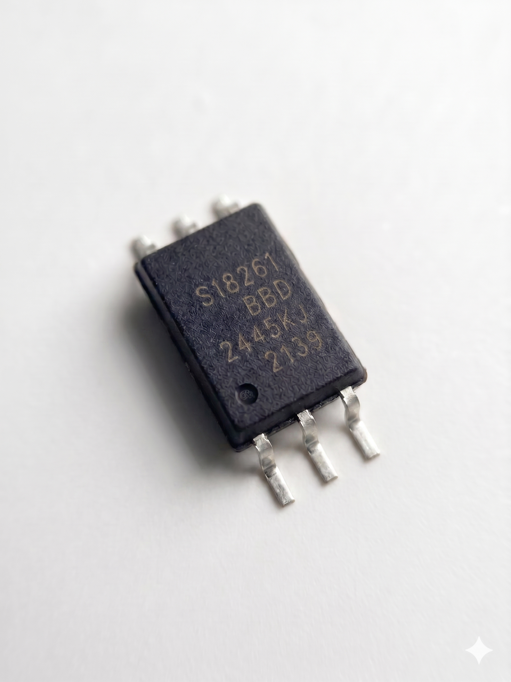 Professional photograph of a centered Silicon Labs Si8261BBD-C-IS isolated gate driver IC in a 6-pin SDIP package with technical markings, viewed from the front top-down perspective on a pure white studio background.