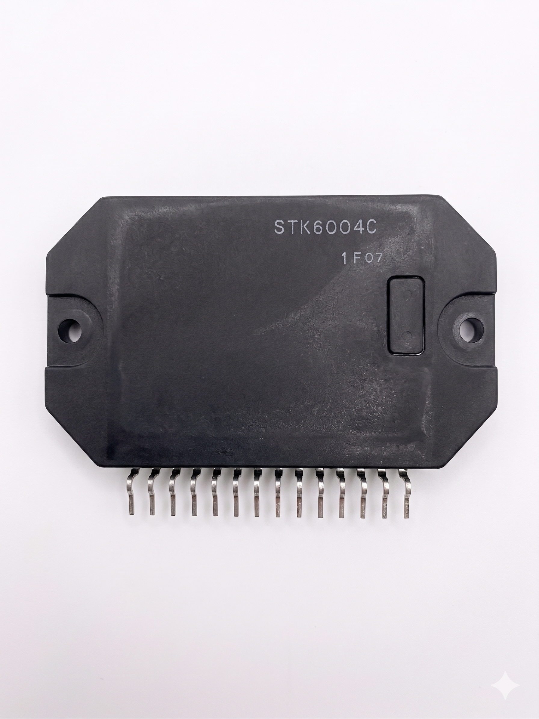 Professional studio photo of STK6004C Power Hybrid IC 14-pin DIP package featuring real laser-etched markings on a pure white background with no extra text overlays.